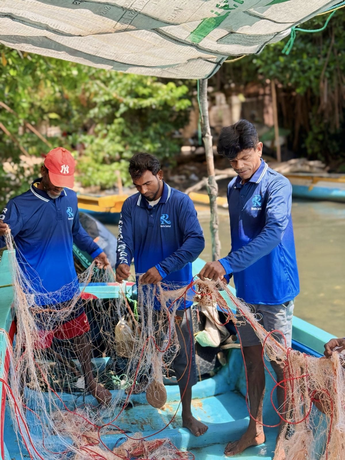 Team mending fishing nets